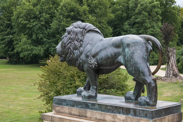lion statue in front of red castle of Fuerst Pueckler in Bad Muskau Germany