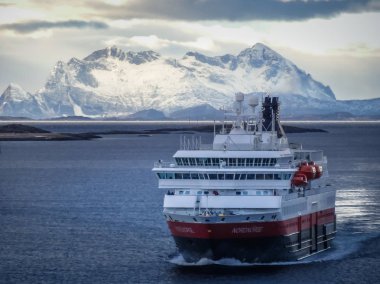Hurtigruten ship nordnorge cruising in winter landscape, norway clipart
