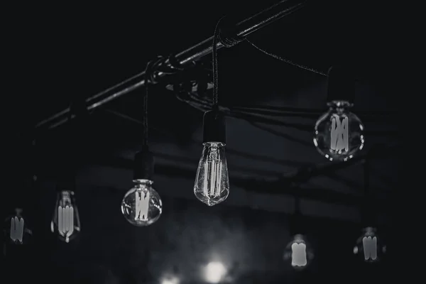 Monocrome shot of vintage light bulbs over a bar