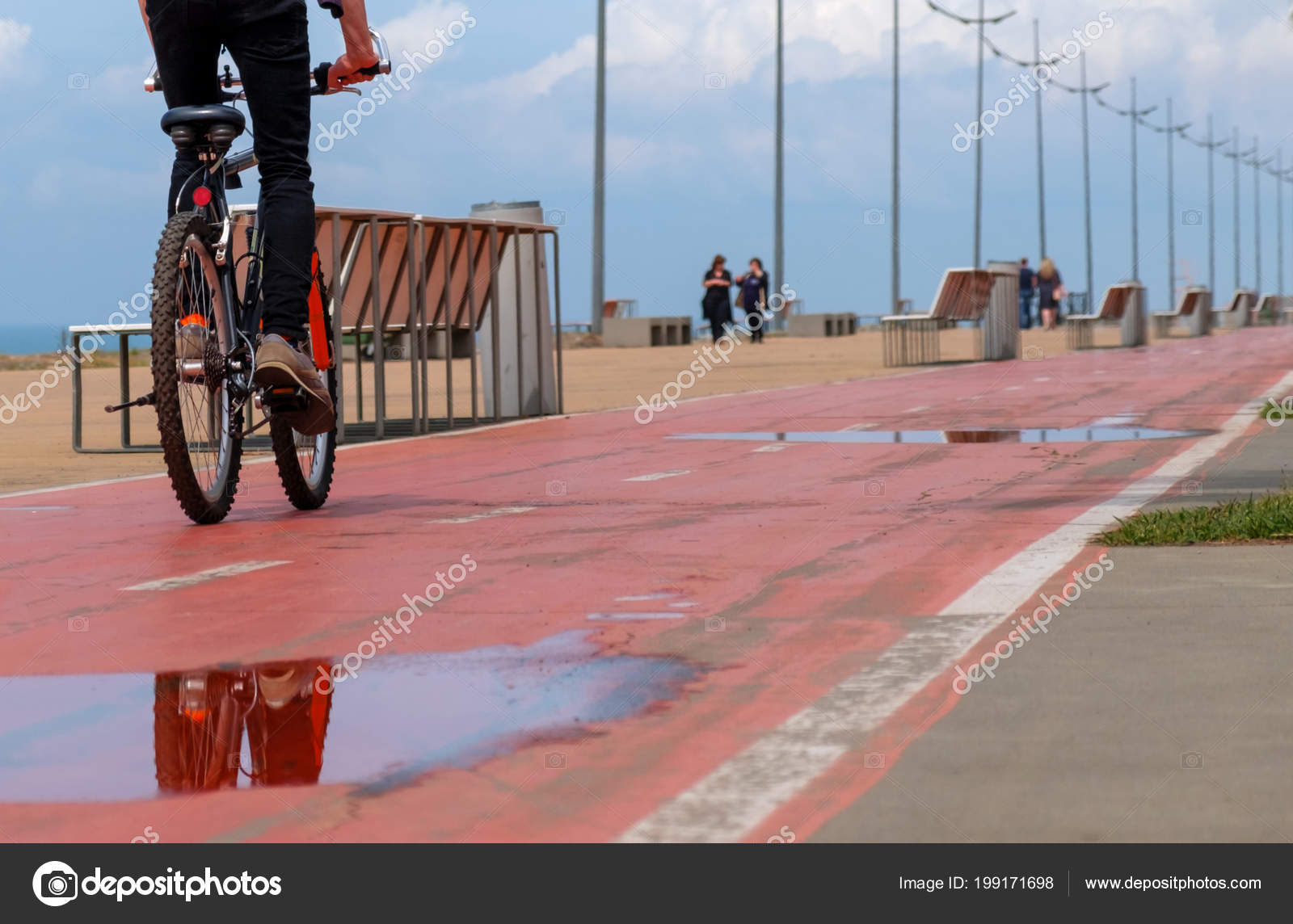 Radfahrer Überquert Pfütze Auf Rotem Fahrradstreifen