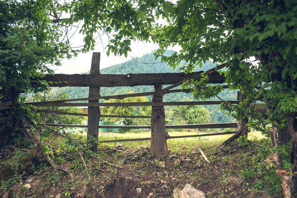 Old rough wooden fence in the village 