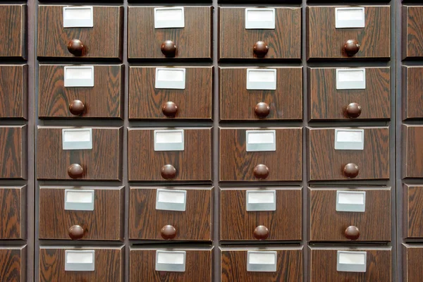 The library's brown wooden catalog file cabinet