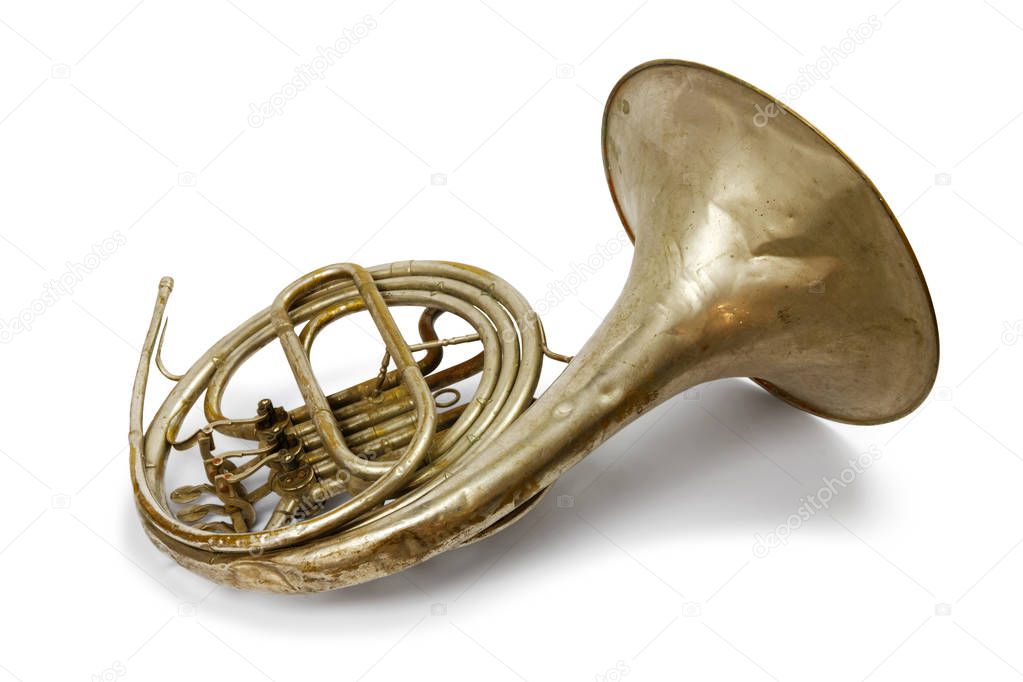 Old vintage French horn with drop shadow on a white background