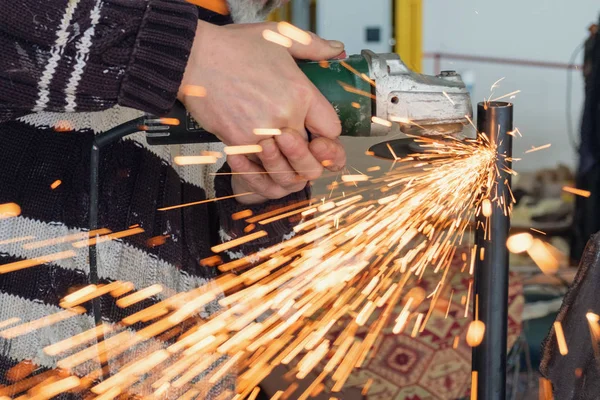 worker working with hand grinder