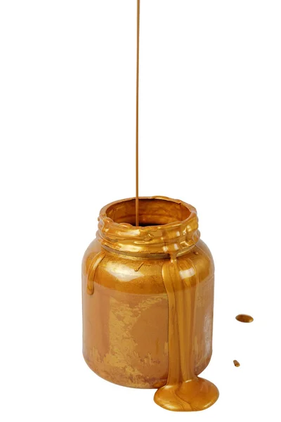 Derramando tinta dourada na lata — Fotografia de Stock