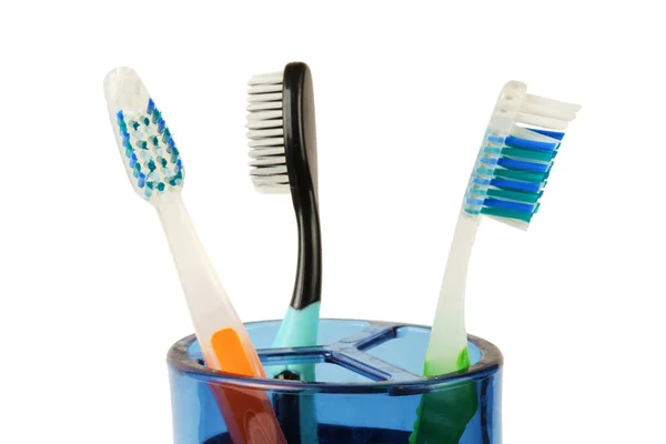 Tooth brushes in a blue plastic cup — Stock Photo, Image