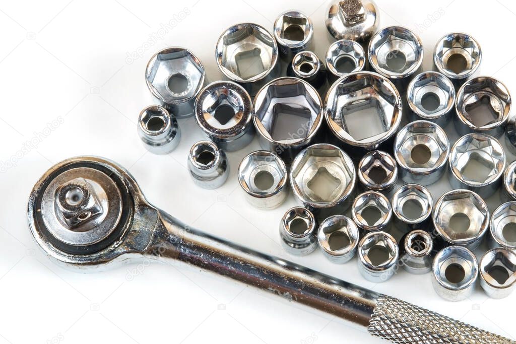 Top view of the socket spanner wrench and various wrench heads closeup on a white surface