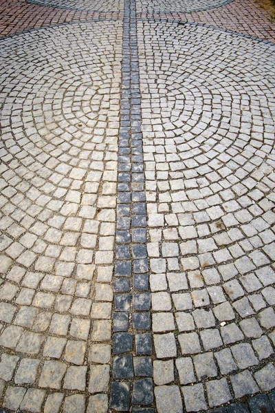 Vintage traditional stone pavement in perspective. Abstract background of old cobblestone pavement