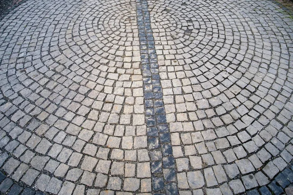 Vintage traditional stone pavement. Abstract background of old cobblestone pavement