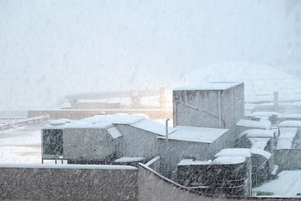 Industrial landscape during heavy snowing