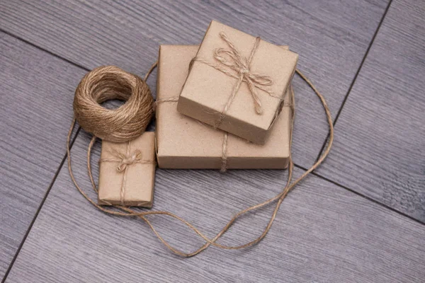 Handmade craft paper package with roll of rope