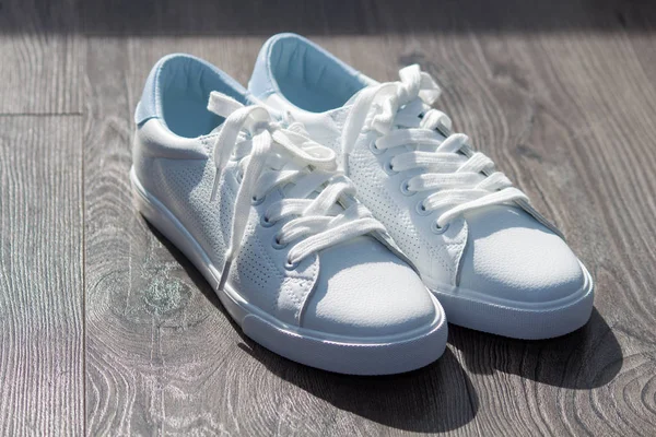 White Leather Female Sneakers Shoes Laces Grey Brown Wooden Background — 스톡 사진