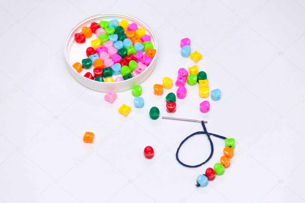 Plastic multicolored beads. Homemade game for children development concept.