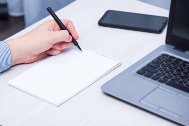 Solak adam deftere yazıyor. Solak Günü konsepti.