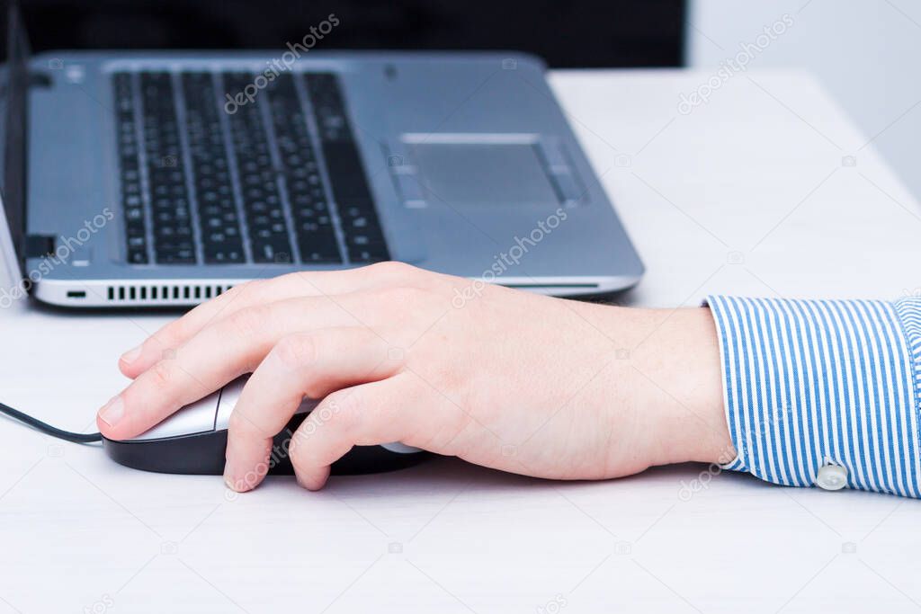 Lefthander using computer mouse with left hand. Left handed day concept.