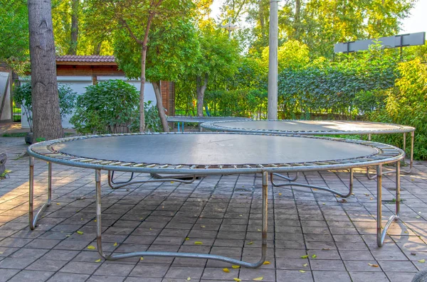 Empty children\'s trampolines in a public park.