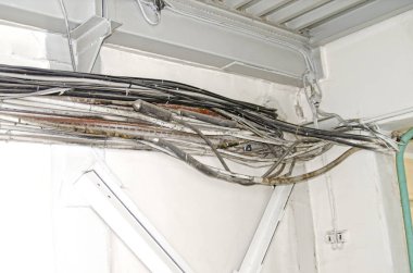 Bir duvar bir endüstriyel bina koridor boyunca eski, kalın kablolar koşmak