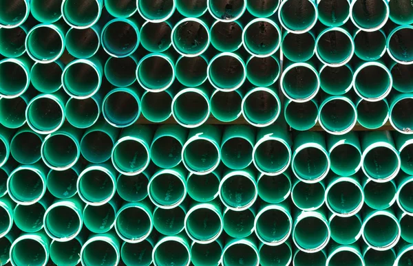 PVC conduit pipes stacked with darkened centers on edge