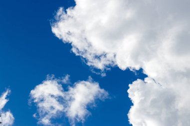 Mavi gökyüzüne karşı hafif kabarık bulutlar