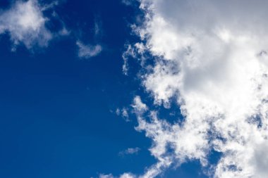 Mavi gökyüzüne karşı hafif kabarık bulutlar