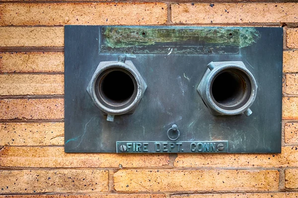 Fire hose nozzles on a building wall