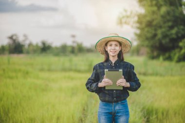 Asyalı kadın çiftçi tablet kavramını kullanıyor akıllı çiftçi