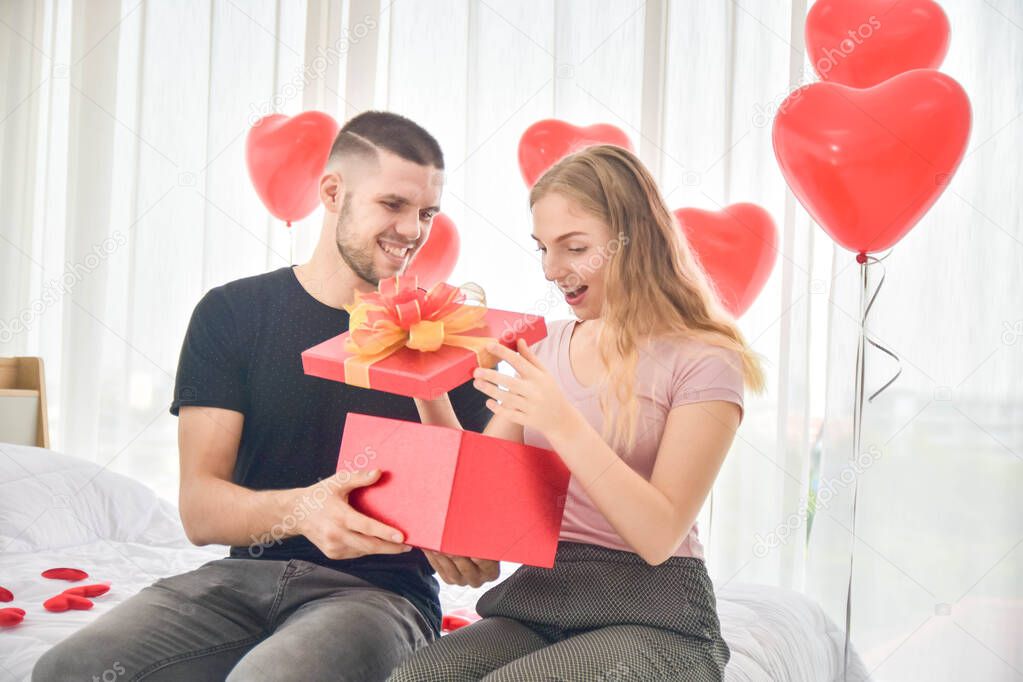 Love Couple giving gift box in bedroom happiness in love Valentine's day concept