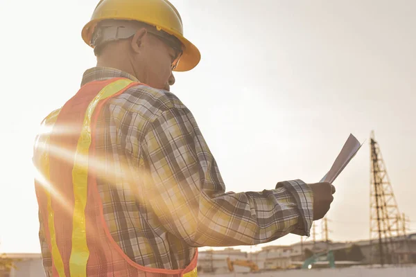 Engineer construction holding paper blueprint inspection building estate construction project