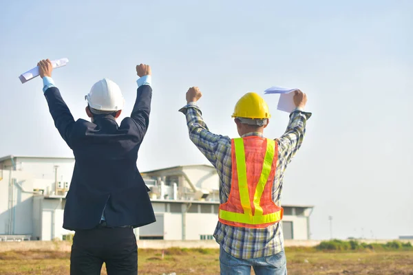 Project manager and Engineer construction holding hand success project,Production manager and Engineer holding hand success project factory background