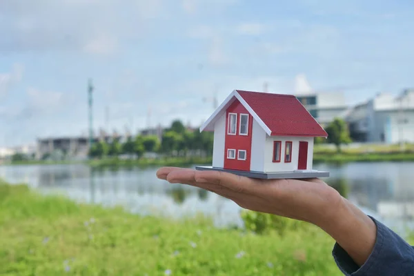 Hand holding house model concept business finance sale rent  real estate