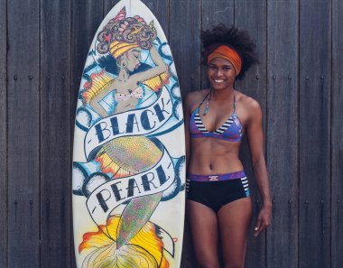 young gorgeous african-american woman posing with surfboard  clipart