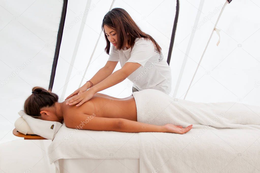 female asian massagist making massage for relaxing woman