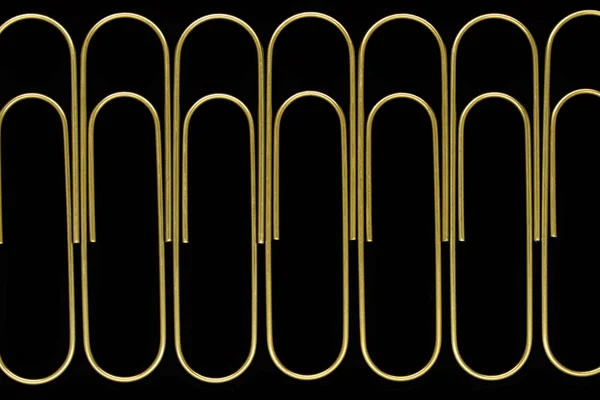 Group Sharp Clear View Golden Paperclips Standing Line Black Background — Stock Photo, Image