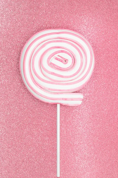 Round marshmallow lollipop on stick on shiny pink background