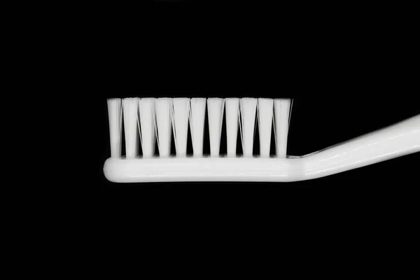 White toothbrush isolated on black background — Stock Photo, Image