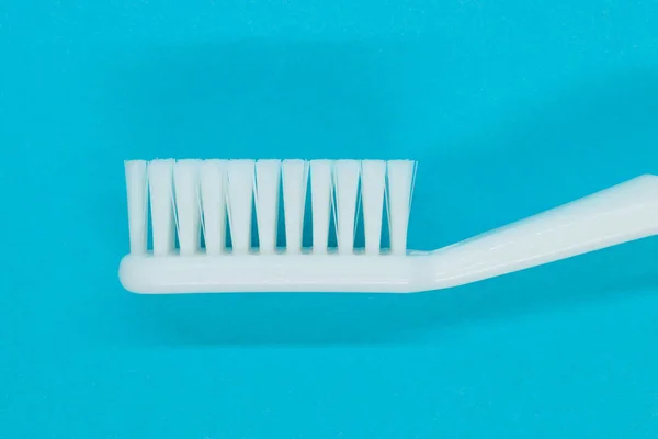 White toothbrush on blue background — Stock Photo, Image