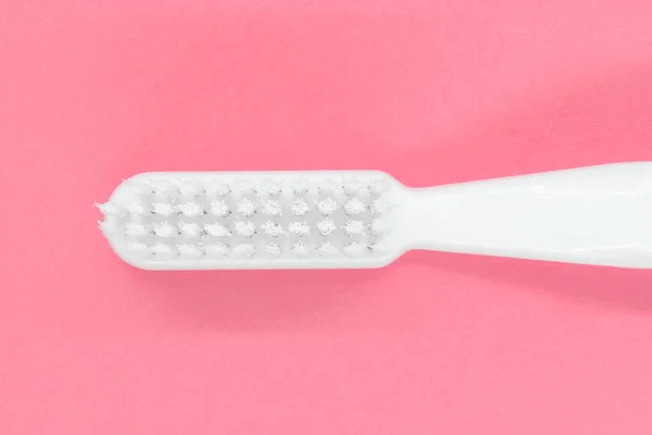 White toothbrush on pink background — Stock Photo, Image