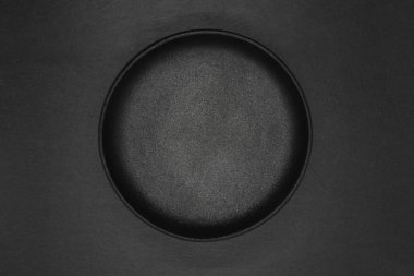 Cast iron bowl on grey stone background