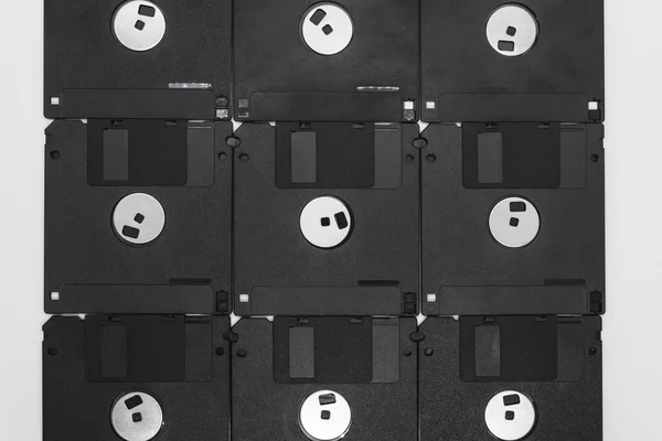 Background of black floppy disks on white background — Stock Photo, Image