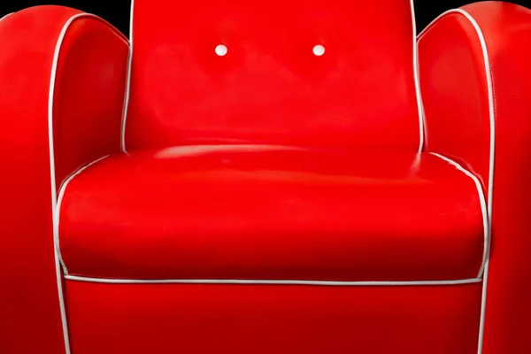Part of luxury red armchair and white edgings isolated on black background