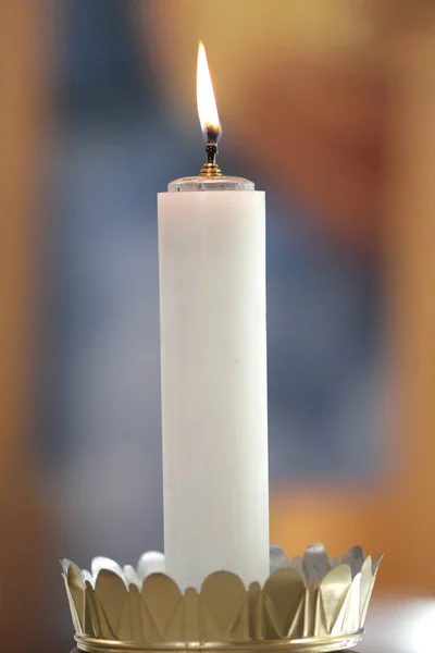 candle lit during a Catholic mass,isolated