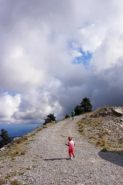 little girl climbs the mountain road in Evia, Greece