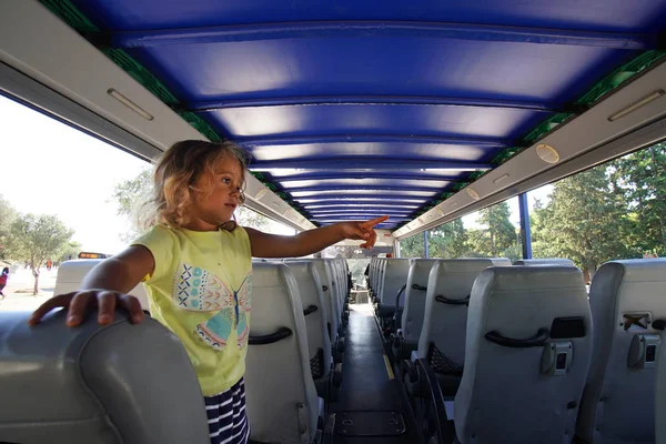 Little blonde little girl in a tourist bus in Athens,Greece