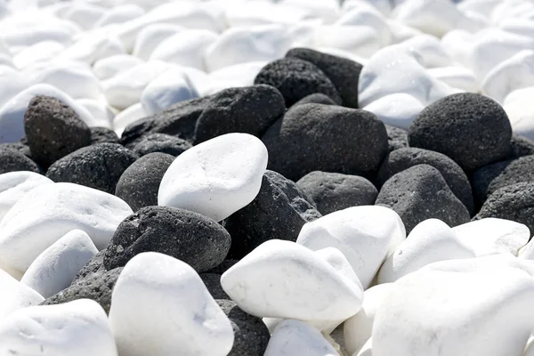 Black and white volcanic stones in Oia, Santorini, Greece