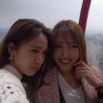 Cute Japanese women high above Osaka city taking pictures togeather, 4K