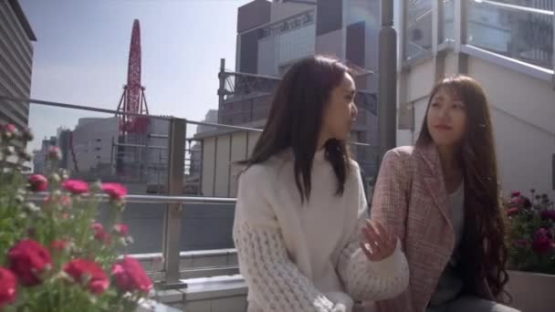 Mujeres sentadas al sol disfrutando de la primavera en la ciudad de Osaka, 4k — Vídeo de stock