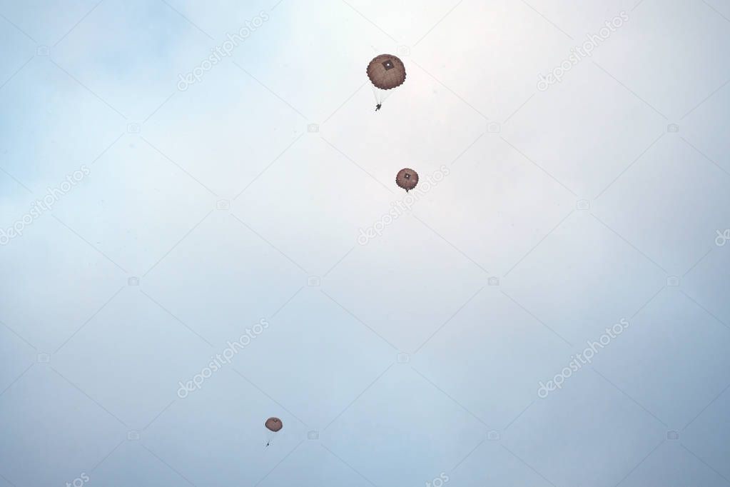 Three paratroopers are in the sky.