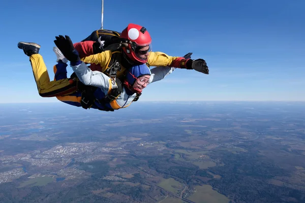 Skydiving. Tandem jump. A man and a woman are having fun in the sky.