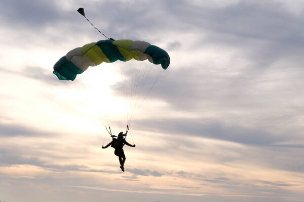 Skydiving. A parachute is in the beautiful sky.