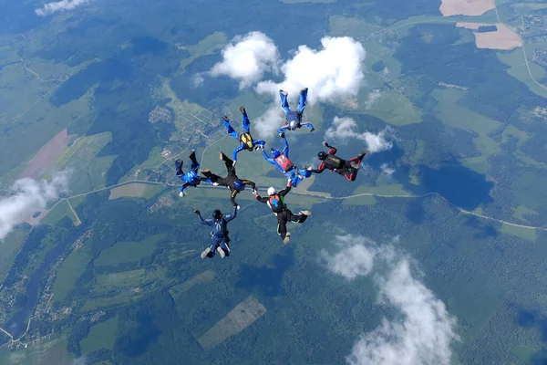 Formation skydiving. A group of skydivers are training in the sky.
